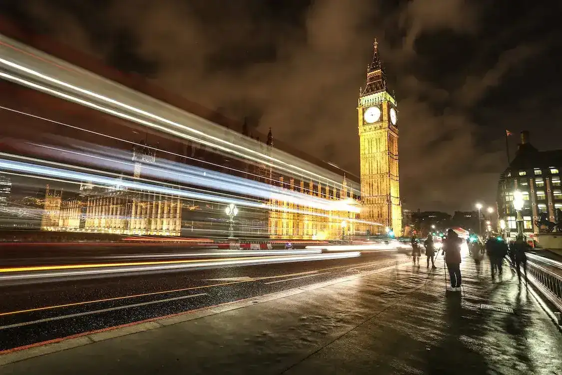 Night view of Big Ben with light trails in London.
