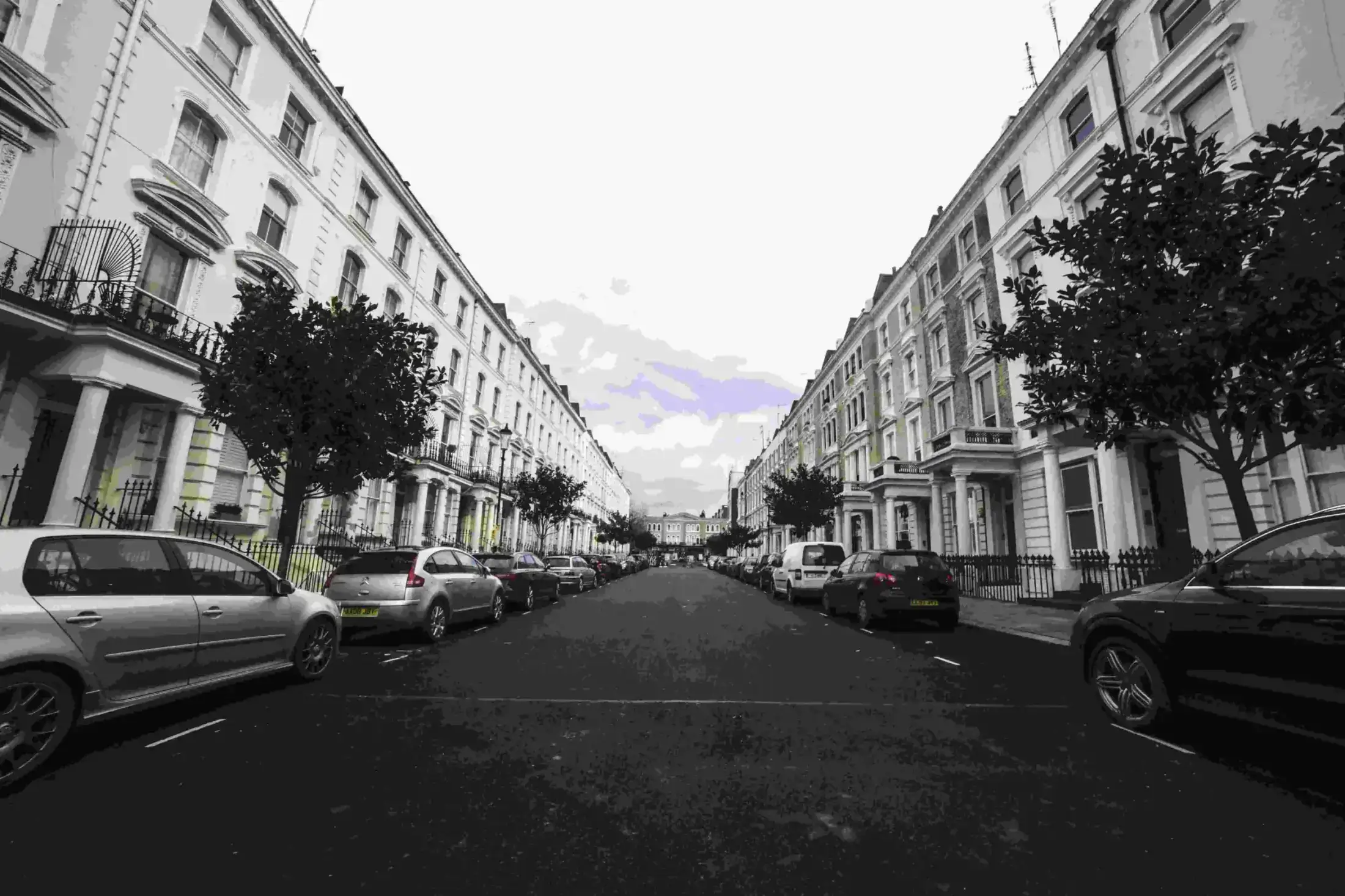 Wide-angle shot of a classic London street with terraced houses.