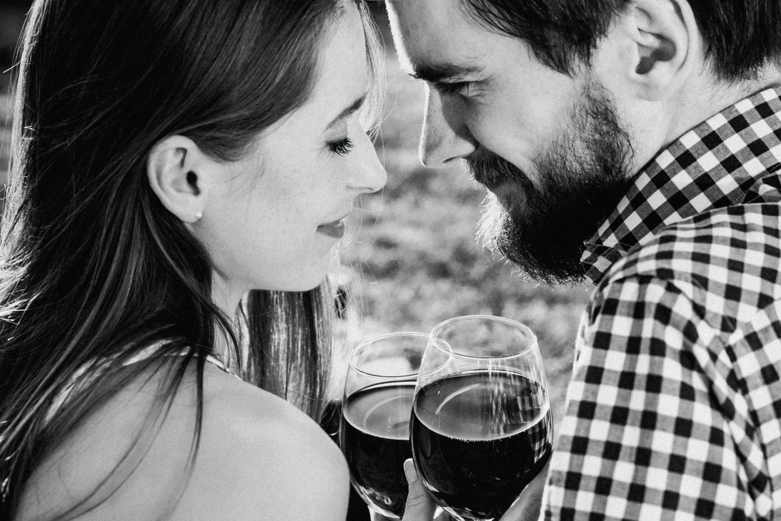 Couple sharing a romantic moment with wine glasses.