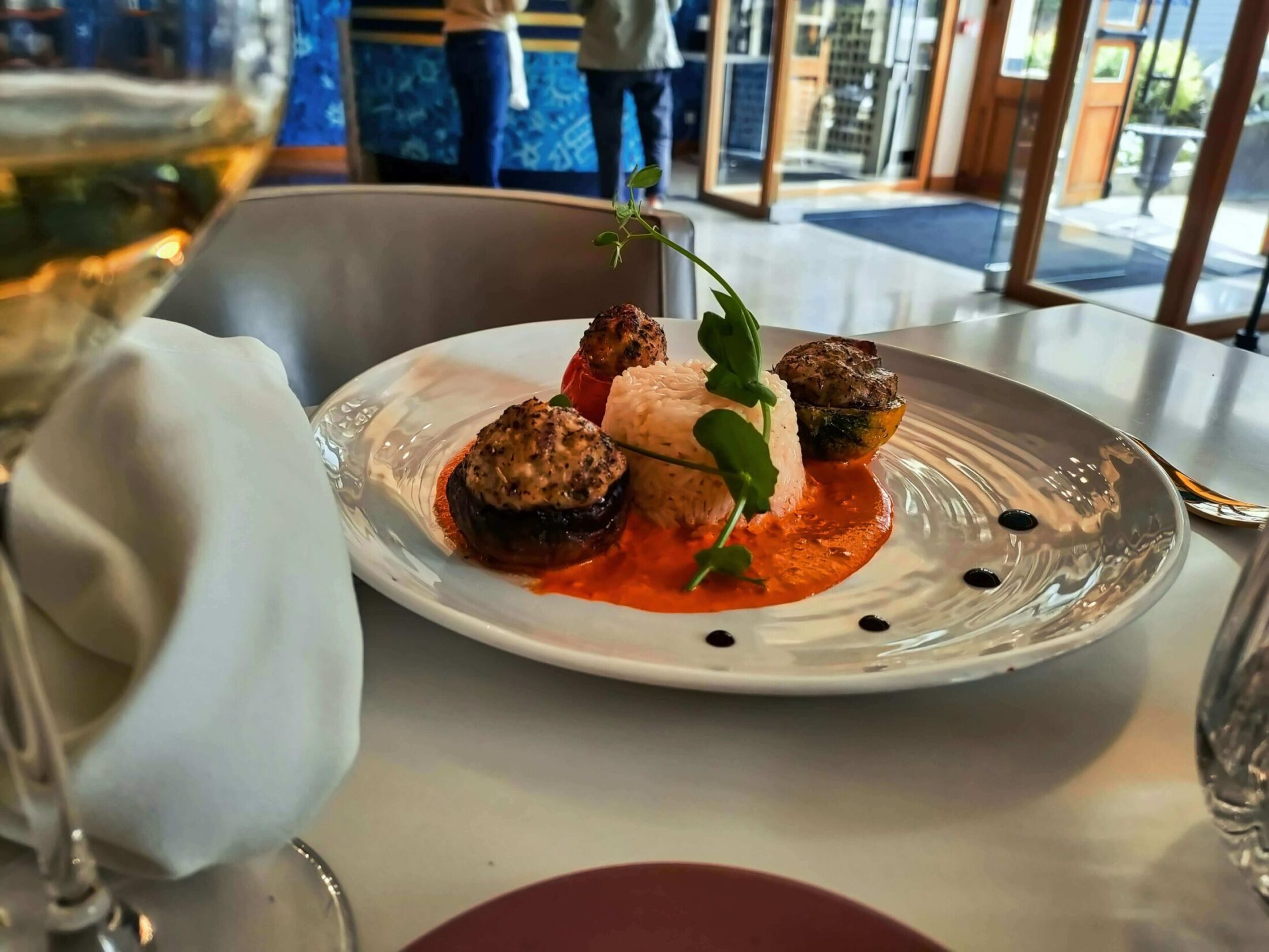 Gourmet stuffed vegetables with rice and orange sauce.