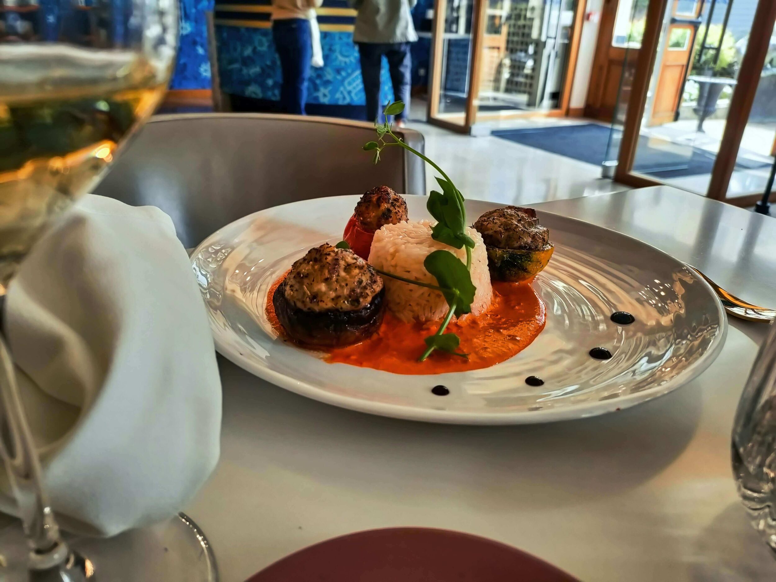 Gourmet stuffed vegetables with rice and orange sauce.