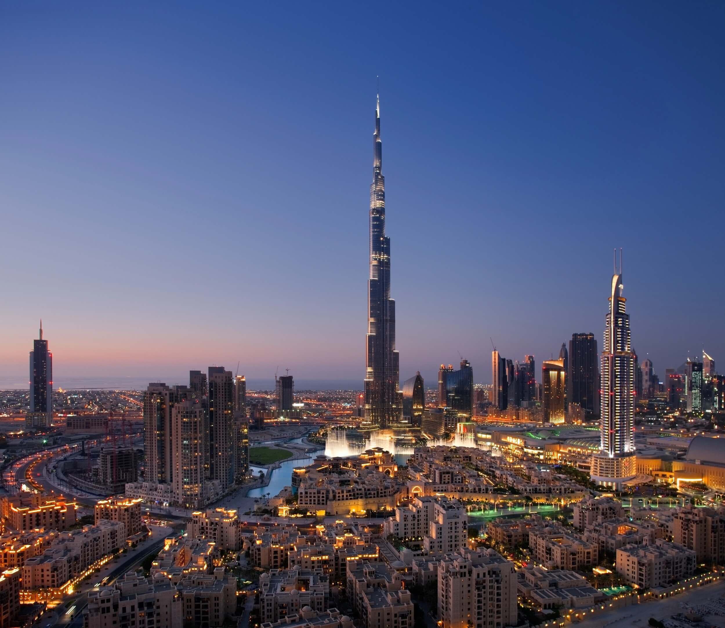 Illuminated Burj Khalifa and Dubai skyline at dusk